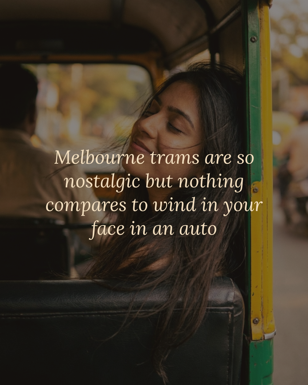 A woman in the back of an auto, hair flying